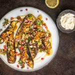 Auberginen aus dem Ofen mit Mandeln, Sesam-Joghurt, Kräutern und einem Orangen-Zimt-Dressing